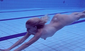 Proklova takes absent bikini with an increment of swims under water